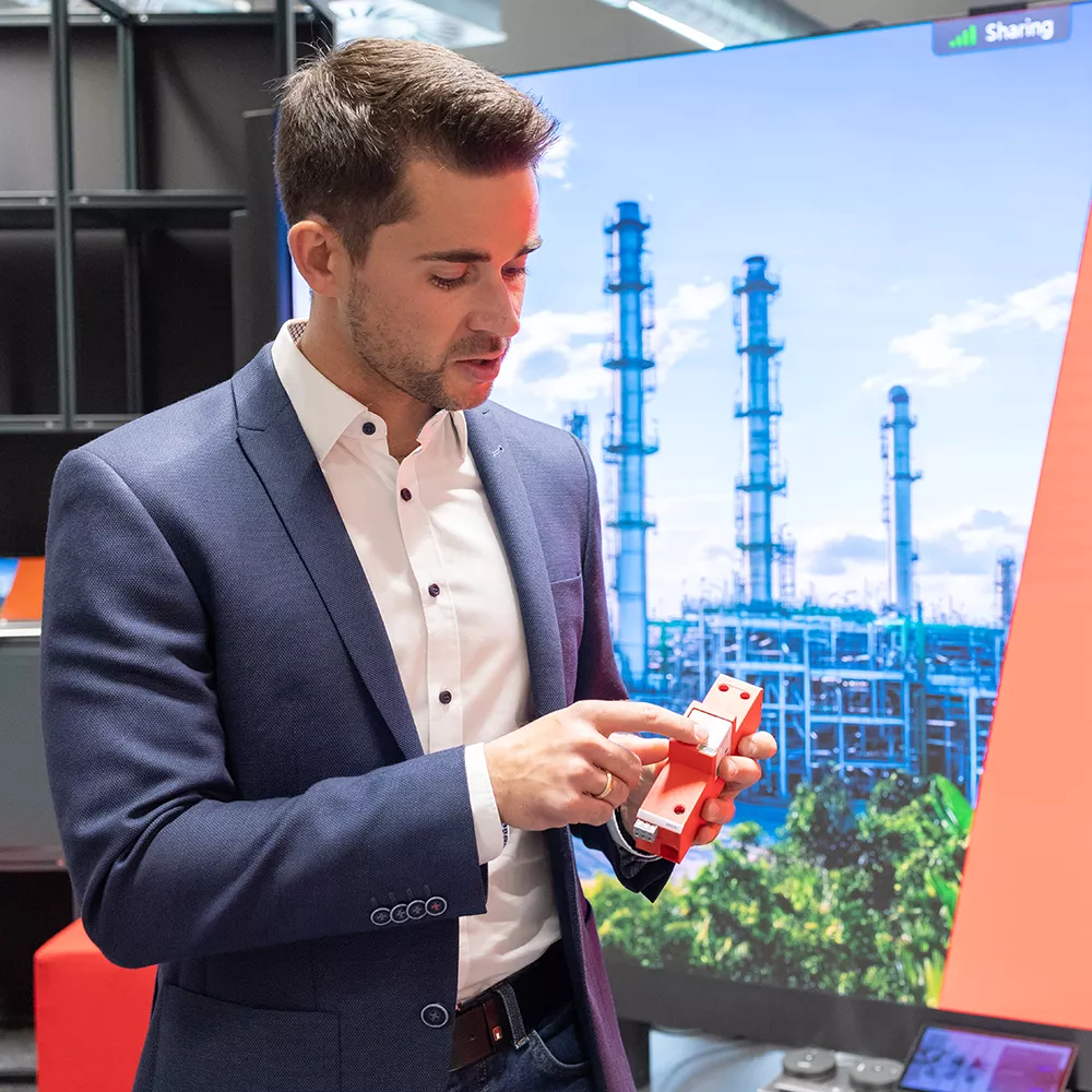 Man, explaining something about a surge protection device