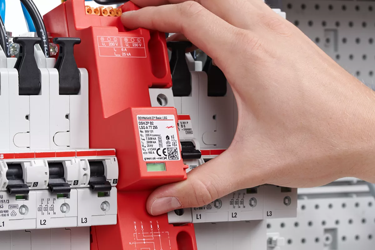 Close-up of an electrical distribution board showing circuit breakers, wiring, and a prominent DEHNshield ZP surge protection device.